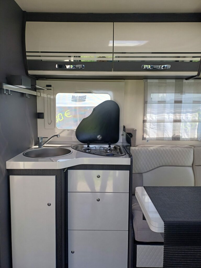 modern kitchen equipped with a sink and a 3-burner stove in a CI 67 integral motorhome.