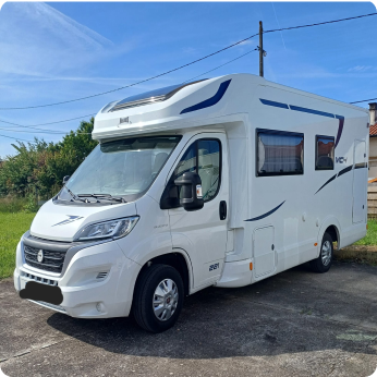 Vue latérale d'un camping-car blanc garé sur le bitume, avec un design épuré et des accents bleus sur le côté